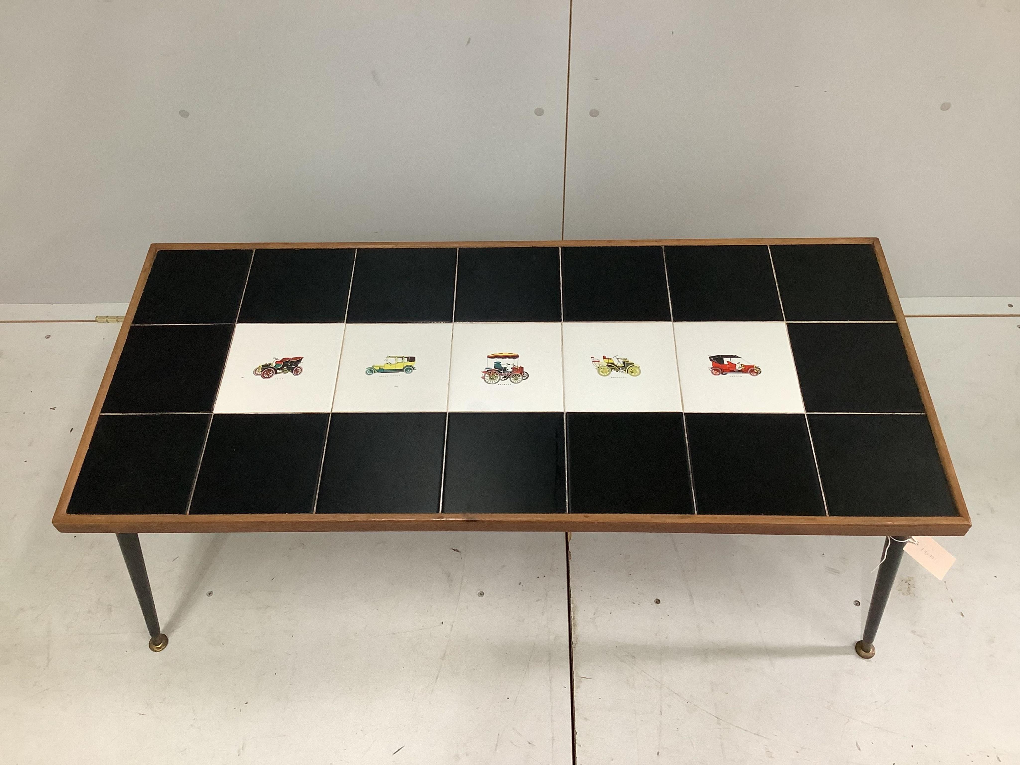 A 1960s tile top coffee table, width 110cm, depth 48cm, height 51cm. Condition - fair to good